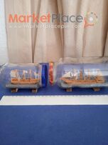 Δύο χειροποίητα ξύλινα πλοία σε μπουκάλι.